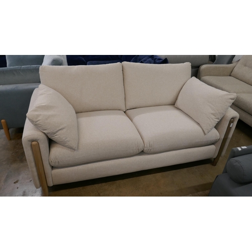 1431 - An oatmeal  upholstered 2.5 seater sofa on semi exposed frame