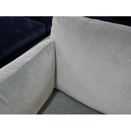 1438 - A steel blue velvet two seater sofa on semi exposed frame