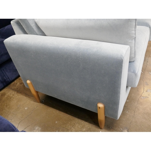 1438 - A steel blue velvet two seater sofa on semi exposed frame