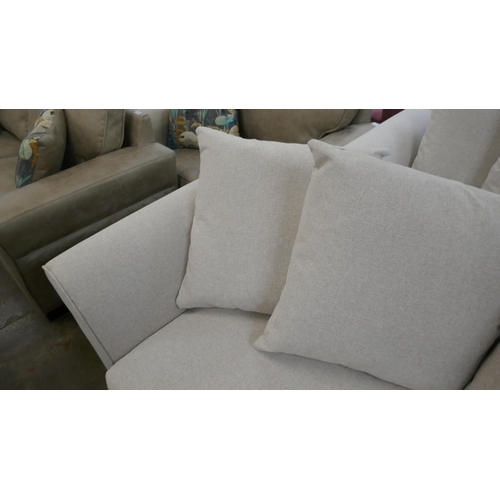 1445 - An oatmeal upholstered three seater sofa, two seater sofa, armchair and footstool