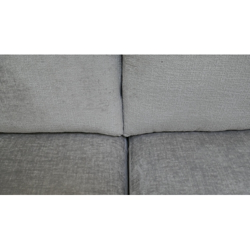 1461 - A pewter velvet four seater sofa