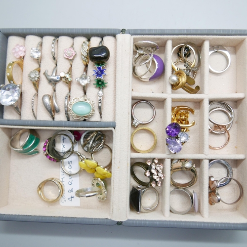 1003 - A large collection of rings, a silver and moonstone ring, rose quartz, etc., over 100