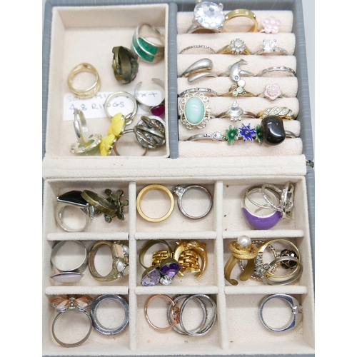 1003 - A large collection of rings, a silver and moonstone ring, rose quartz, etc., over 100