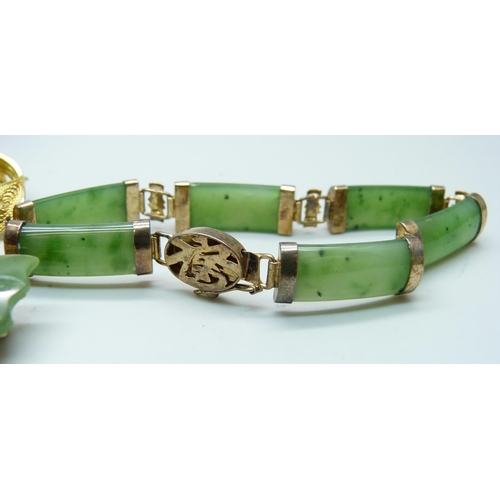 1061 - A silver set jade bracelet, two jade set brooches and an enamelled pin