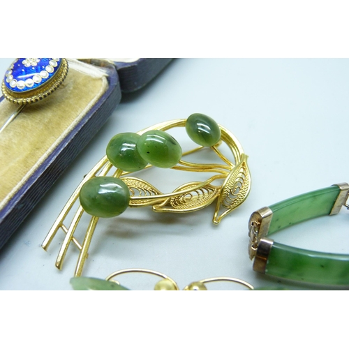 1061 - A silver set jade bracelet, two jade set brooches and an enamelled pin