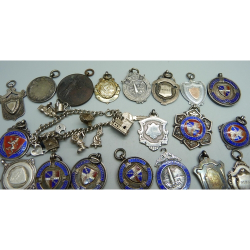 1063 - Twenty-three silver fob medals, some enamelled, 214g, four other fob medals and a charm bracelet