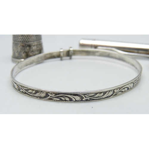 1064 - A hallmarked silver pencil, a plated Evesharp pencil, a silver bangle and a silver thimble