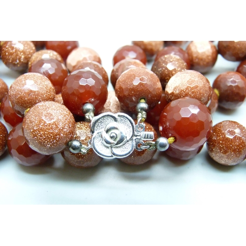 1069 - A heavy faceted goldstone and dark red stone bead double string necklace with silver clasp, 278g