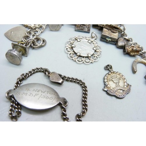 1070 - A silver charm bracelet, two silver pendants and a bracelet, 68g