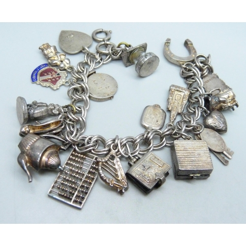 1070 - A silver charm bracelet, two silver pendants and a bracelet, 68g