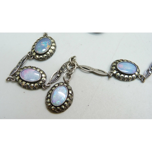 1086 - A opal set silver brooch, a pair of opal and silver drop earrings and a silver, marcasite and opal n... 