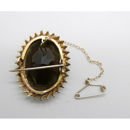 1123 - A yellow metal and smoky quartz set brooch, tests as 9ct gold, 10.3g