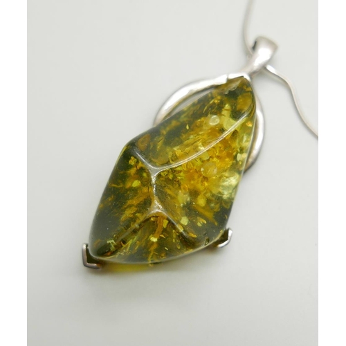 1126 - Two silver and green amber pendants and chains