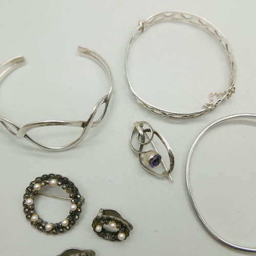 1158 - A silver Charles Horner brooch, three silver bangles, one set with two small diamonds, and a silver,... 