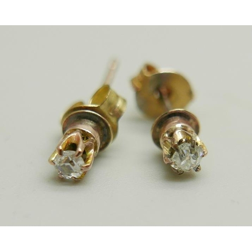 1196 - A pair of 9ct gold and diamond ear studs