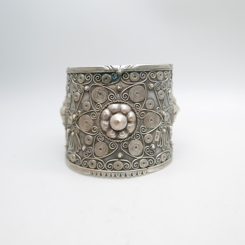 1207 - An ornate wide silver bangle, marked 84 and 800, 62g