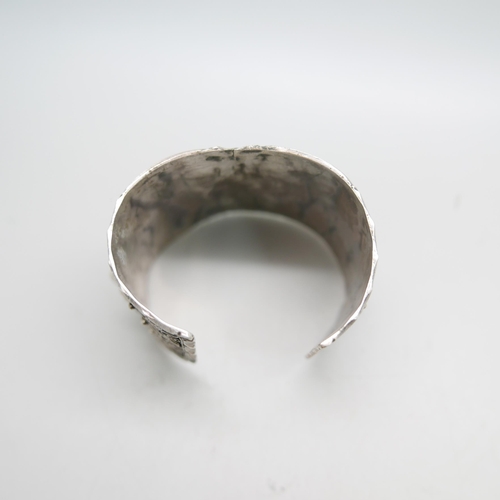 1207 - An ornate wide silver bangle, marked 84 and 800, 62g