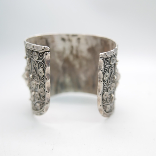 1207 - An ornate wide silver bangle, marked 84 and 800, 62g