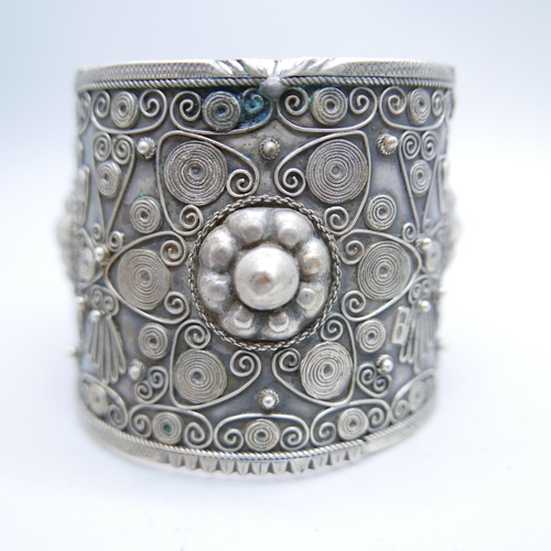 1207 - An ornate wide silver bangle, marked 84 and 800, 62g