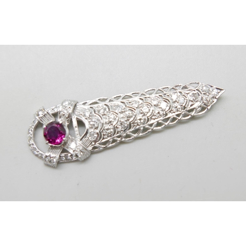 1208A - A white metal pendant set with diamonds and a ruby in an Art Deco style setting, 5.6g, 52mm