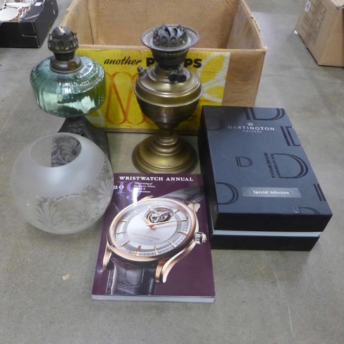 1235 - Two oil lamps lacking chimneys, a pair of Dartington glass champagne flutes, boxed and a 2019 wristw... 