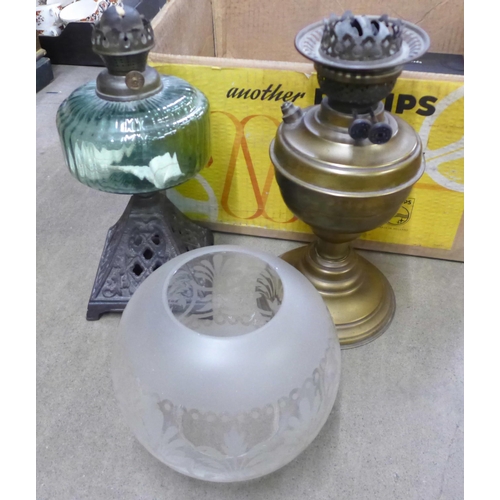 1235 - Two oil lamps lacking chimneys, a pair of Dartington glass champagne flutes, boxed and a 2019 wristw... 