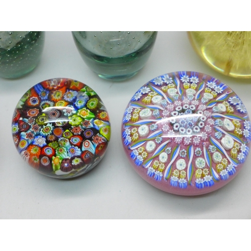 624 - Four glass paperweights, two glass vases, and a resin paperweight