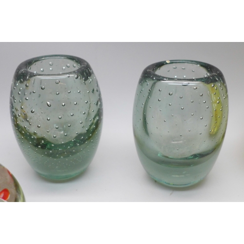 624 - Four glass paperweights, two glass vases, and a resin paperweight