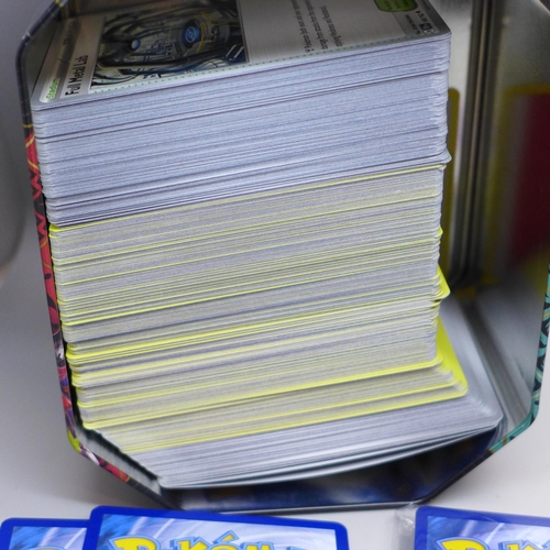 631 - Over 700 Pokemon cards in tins, with holos (two tins)