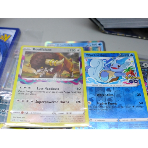 631 - Over 700 Pokemon cards in tins, with holos (two tins)