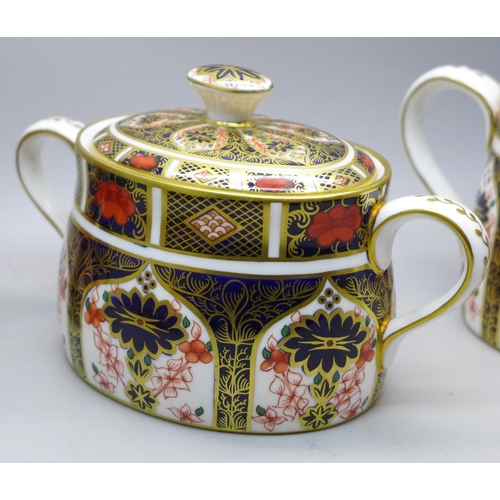 638 - A Royal Crown Derby 1128 Imari pattern cream jug and sugar (x2), smaller milk jug second