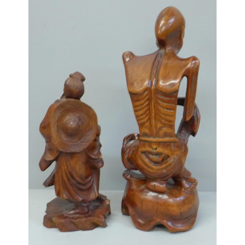 660 - Two carved wooden oriental figures, tallest 21cm, smaller figure with chip to side