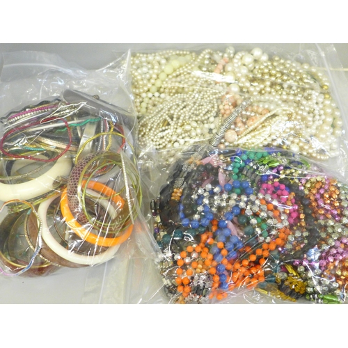 663 - Three bags of costume jewellery including bangles, necklaces and faux pearls