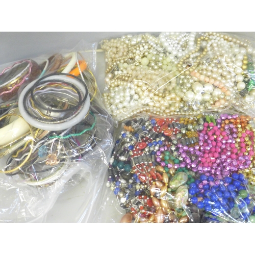 663 - Three bags of costume jewellery including bangles, necklaces and faux pearls