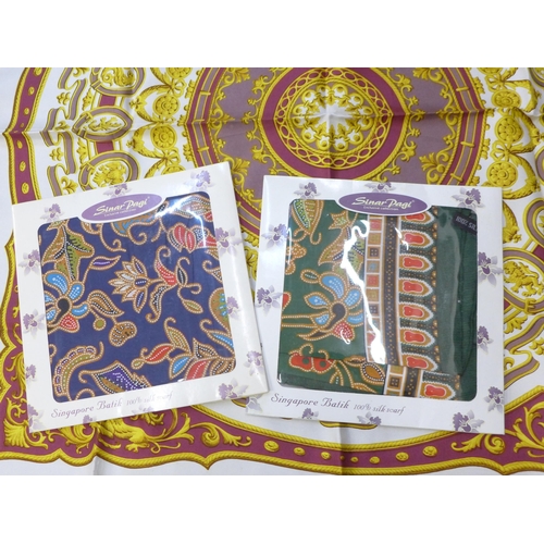 675 - A collection of four lady's silk scarves including two Singapore Batik, packaged