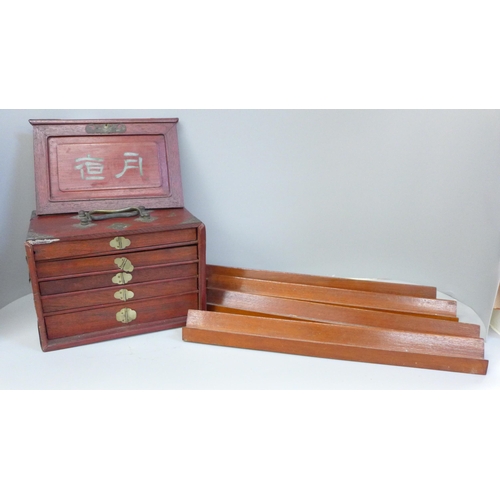 684 - A Mahjong set in original wooden box, bone and bamboo pieces with documents from the Sungei Ljong Cl... 