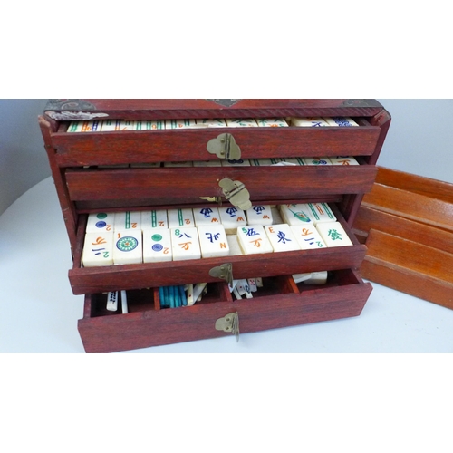 684 - A Mahjong set in original wooden box, bone and bamboo pieces with documents from the Sungei Ljong Cl... 