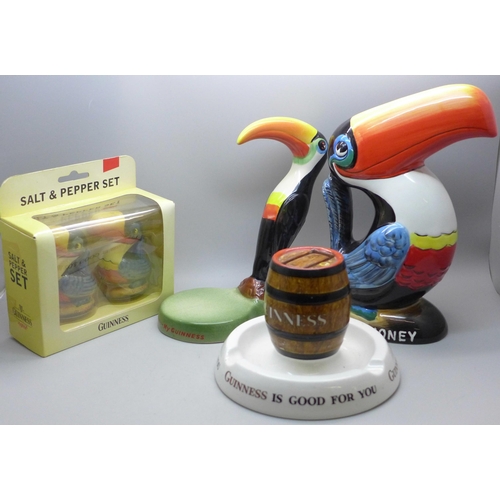 705 - Guinness advertising items; a Carlton Ware Toucan figure, a Toucan Beer Money box, a Mintons matchbo... 