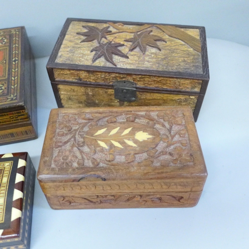 768 - Six boxes; three inlaid wooden boxes, an oriental carved wooden box, a metal inlaid box and one othe... 