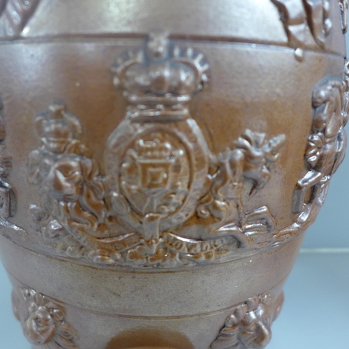 803 - A saltglaze wine barrel with applied Royal Coat of Arms, Knights, Lions and Oak Leaves, 31cm