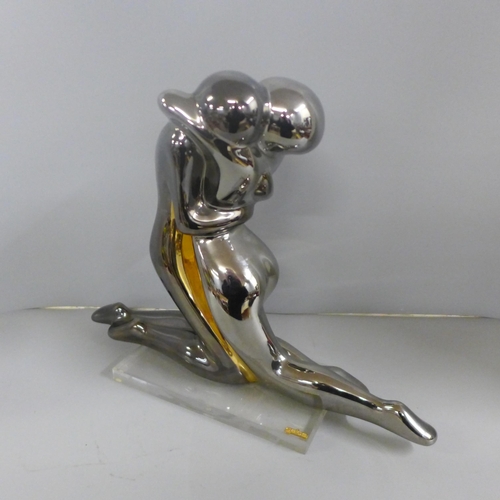 806 - A Galos Spain pottery figure of entwined lovers on a perspex plinth in silver finish, 31cm