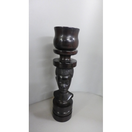 813 - Tribal art; large wall mounted teak carved face mask (37cm tall) and a pair of hardwood turned candl... 