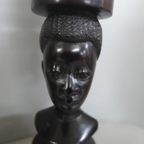 813 - Tribal art; large wall mounted teak carved face mask (37cm tall) and a pair of hardwood turned candl... 