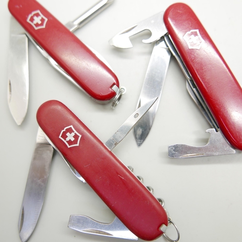 876 - Three Victorinox Swiss multi-tool knives