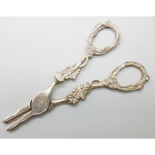 914 - A Victorian silver spoon by George Adams, a strainer and a pair of silver grape scissors, (spoon and... 