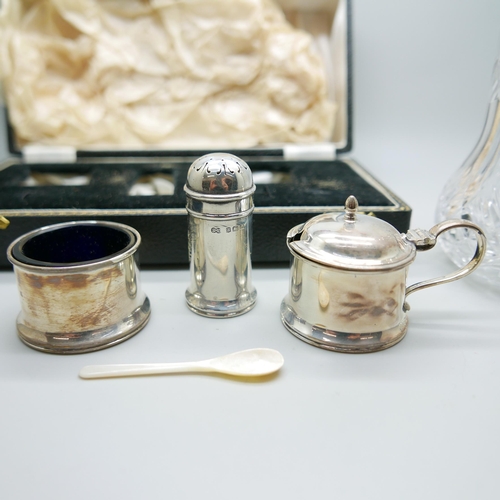 938 - A silver condiment set, cased, and a silver topped shaker, 80g