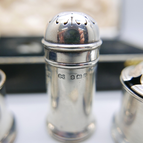 938 - A silver condiment set, cased, and a silver topped shaker, 80g