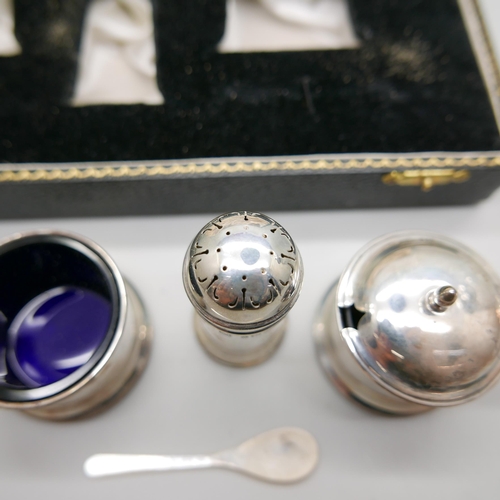 938 - A silver condiment set, cased, and a silver topped shaker, 80g