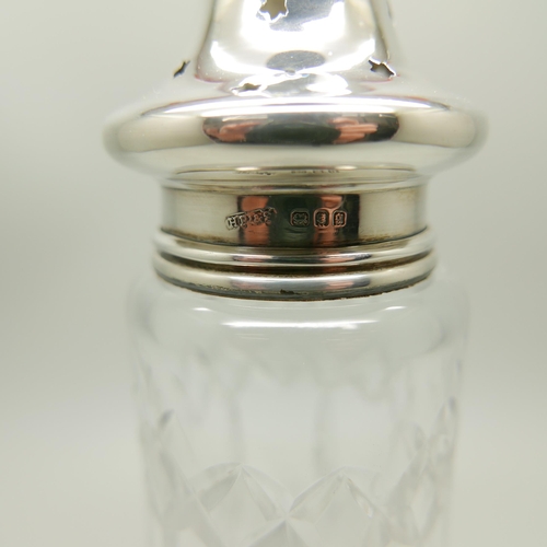 938 - A silver condiment set, cased, and a silver topped shaker, 80g