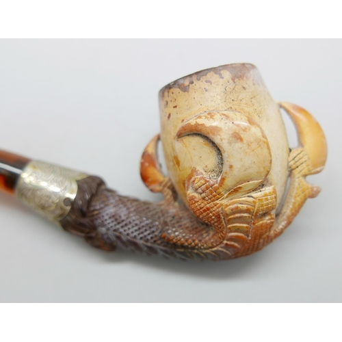 939 - An early 20th Century eagle's claw, pipe, with amber stem and silver collar, cased Meerschaum